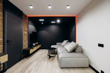 A modern living room featuring stylish decor and elegant lighting throughout the space