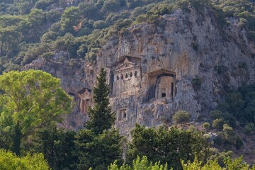 Cliffside tombs in a green landscape - Caunos Tombs of the Kings - Dalyan - Mugla - Turkey