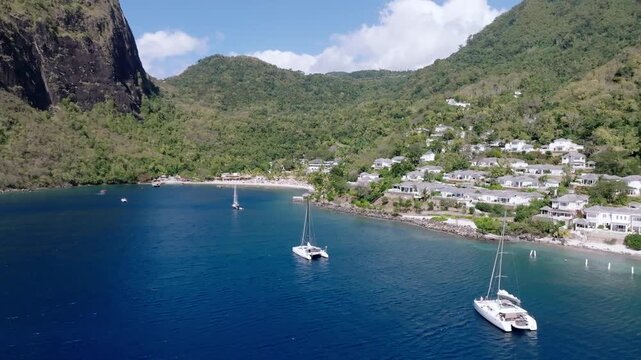 Aerial view of the impressive Pitons contrasting the deep blue sea with sailing boats and the green lush coastline, Le Pitons, Soufri&egrave;re, Saint Lucia.