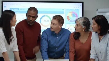 Diverse team of professionals engaged in a discussion around data analytics in a modern office setting - Powered by Adobe