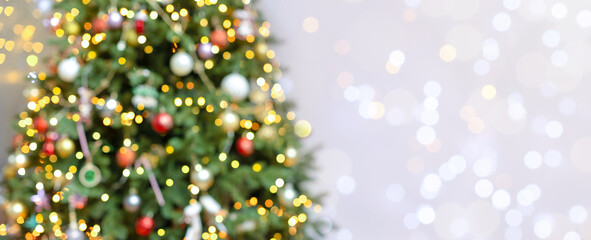 Christmas banner with space for copy, Christmas trees with blurred lights and highlights. Beautiful festive background with space for copy, text and advertising. Glare and blurred lights on a light