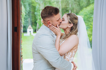 Fototapeta premium happy, laughing bride and groom at the wedding. Celebrate an emotional wedding. Kiss.