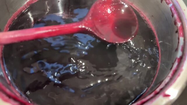 cooking elderberry fruit juice in pot