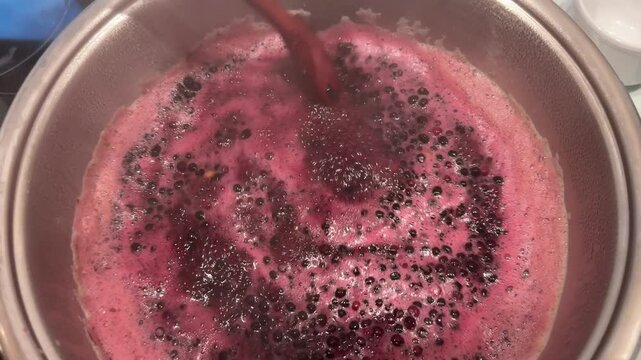 cooking elderberry fruit juice in pot