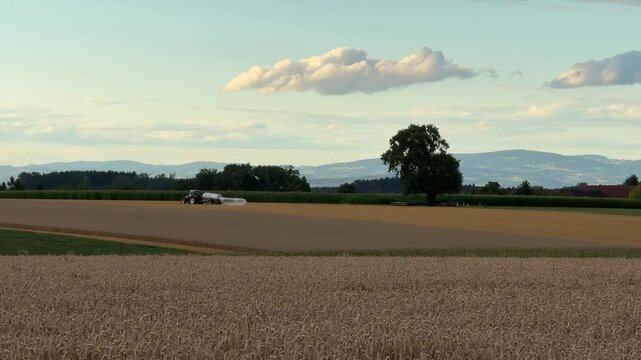manure tank distributing liquid manure on agricultural field