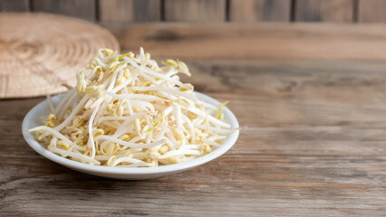 Pile of bean sprouts glistens on rustic plate, embodying Lunar New Year prosperity, culinary...