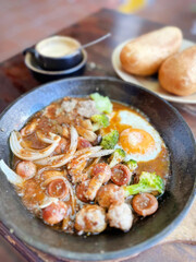 Sizzling breakfast skillet with umami burst, juicy sausages, and fried egg halos; perfect for International Bacon Day feasting