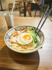 A steaming bowl of ramen crowned with a vibrant sunny egg invites culinary zen, perfect for Tanabata or Noodle Day