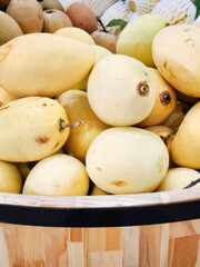 Golden mangoes nestled in a rustic basket, evoking tropical harvest festivals and culinary adventures in sun-soaked lands