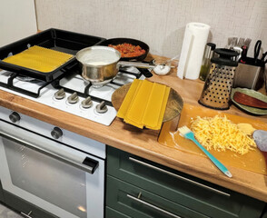 Cozy pasta-making scene with scattered ingredients amidst culinary chaos, capturing the spirit of Italian Festa della Pasta