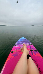 Peaceful solitude on vibrant paddleboard, serene legato of a clouded sky, celebrating World Oceans...