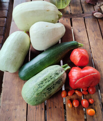 Sunlit garden bounty of quirky zucchini and bulbous heirloom tomatoes, celebrating Lughnasadh harvest and vibrant plant-based feasts