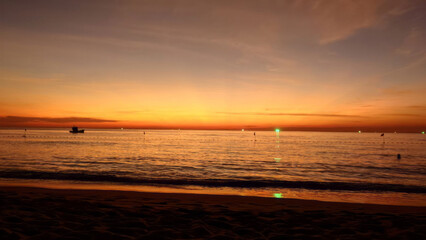 Sunset hues dance over tranquil waves as evening whispers secrets of midsummer solstice magic and coastal introspection rituals