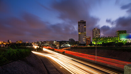 Ghana Accra city skyline at night with light trails.