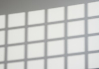 Fototapeta premium Calm interior scene showing a subtle pattern of light and shadow from a window frame