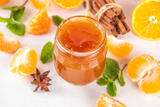 Golden sweet homemade tangerine jam, with spices and mint