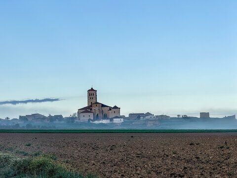 Santa Maria Arbis Church in Baquerin de Campos seen from surrounding farmlands