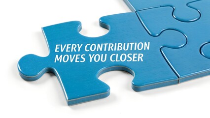 Fototapeta premium Blue Puzzle Piece with Motivational Quote on Contribution and Progress