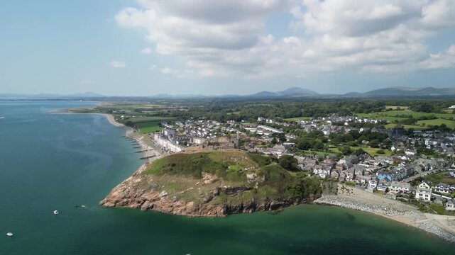 Stunning Criccieth Castle on a lovely summer afternoon - aerial drone anti-clockwise rotate and approach from far - North Wales, UK