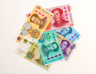 Flat Lay of Chinese Yuan Banknotes and Coins Isolated on White Background.