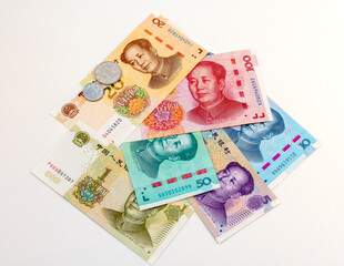 Fan Spread of Chinese Yuan Banknotes and Coins on White Background.