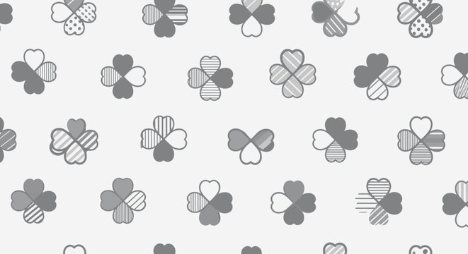 A repeating pattern of four leaf clover graphics with subtle textural designs
