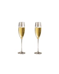 Champagne flutes filled with sparkling drink celebrate a special occasion at an elegant gathering