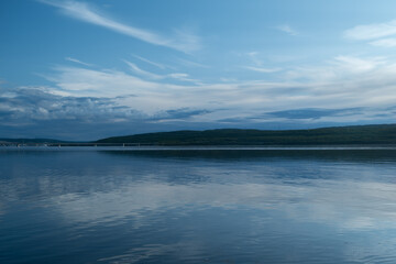 Smooth surface of Barents sea during blue hour. Cinematic scenic natural background.