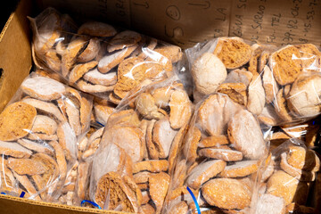 Plastic bags with brown cookies in cardboard box