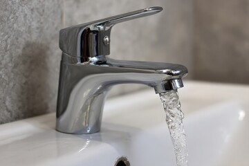 Turn Off Faucet to Save Water. Close-up of Water Tap Handle in Bathroom