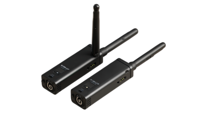 Two black wireless audio transmitters, angled, showing a slightly smaller and larger unit.  Each has a long antenna and a rectangular body with a circular input/output port on the side.