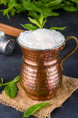 Turkish buttermilk in a copper cup on black background. Turkish yogurt drink
