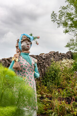 A quirky, beautiful scarecrow in a rural cottage garden: Chapel Lane, Tissington, Derbyshire, England