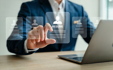 Professional business person in a sharp suit interacting with a futuristic holographic interface displaying digital data and analytics on a laptop.