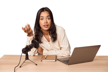 Filipino woman podcasting with mic and laptop