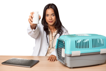Young Filipino vet with laptop and carrier, caring