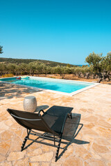 Swimming pool garden and olive trees of typical summer villa on the island of Brac in Croatia