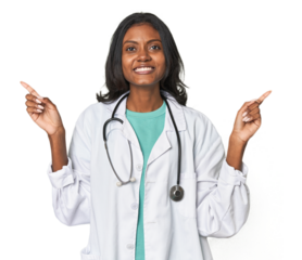 Young Indian doctor with stethoscope indicates with both fore fingers up showing a blank space.