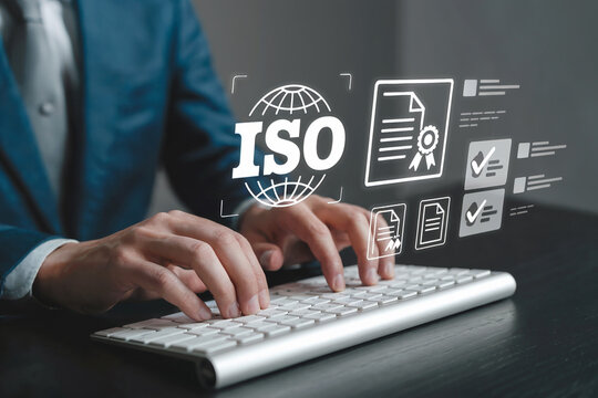Professional businessman typing on keyboard with digital interface showing iso certification and business growth graphics in modern office environment