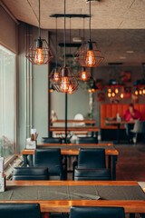 Industrial Cage Lamps in Modern Cozy Cafe Interior