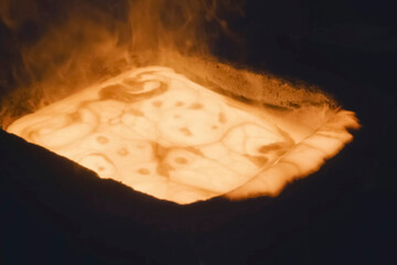 Molten gold pours out of crucible