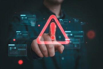 Cybersecurity alert hand touching digital warning triangle over data interface screen with security threat notification and system error.