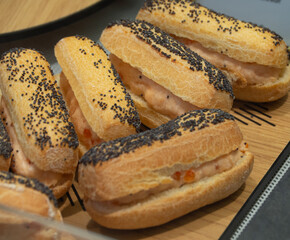 A tray of small sandwiches with pomegranate seeds on top