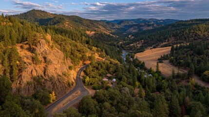 Aerial View Of Winding Road Through Mountain Valley At Sunset