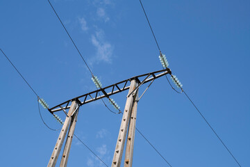 A view of an electric tower with power lines and ceramic insulators