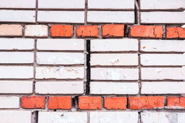 Textured texture of white and red brick.Cracked old brick wall. Brick close-up.