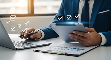 Businessman using digital checklist application on tablet and laptop for online survey and task management, business concept with modern technology