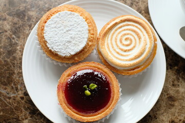tart citron, amandine and Mirliton d'Amiens on the plate
