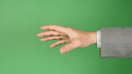 an outstretched hand wearing suit on green screen background.