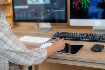 A young freelance woman editing video on a computer at home, representing creative work, digital media, and modern freelance lifestyle